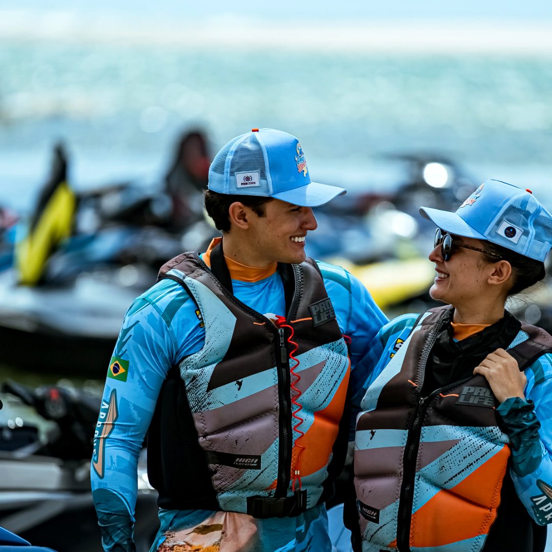 Casal de pilotos sorrindo no pier